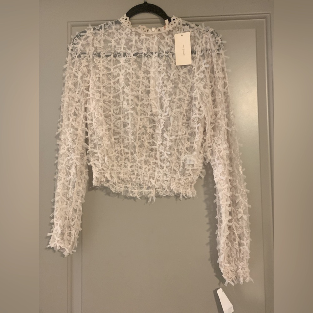 A.peach Brand cream sheer blouse with zipper in the back.
